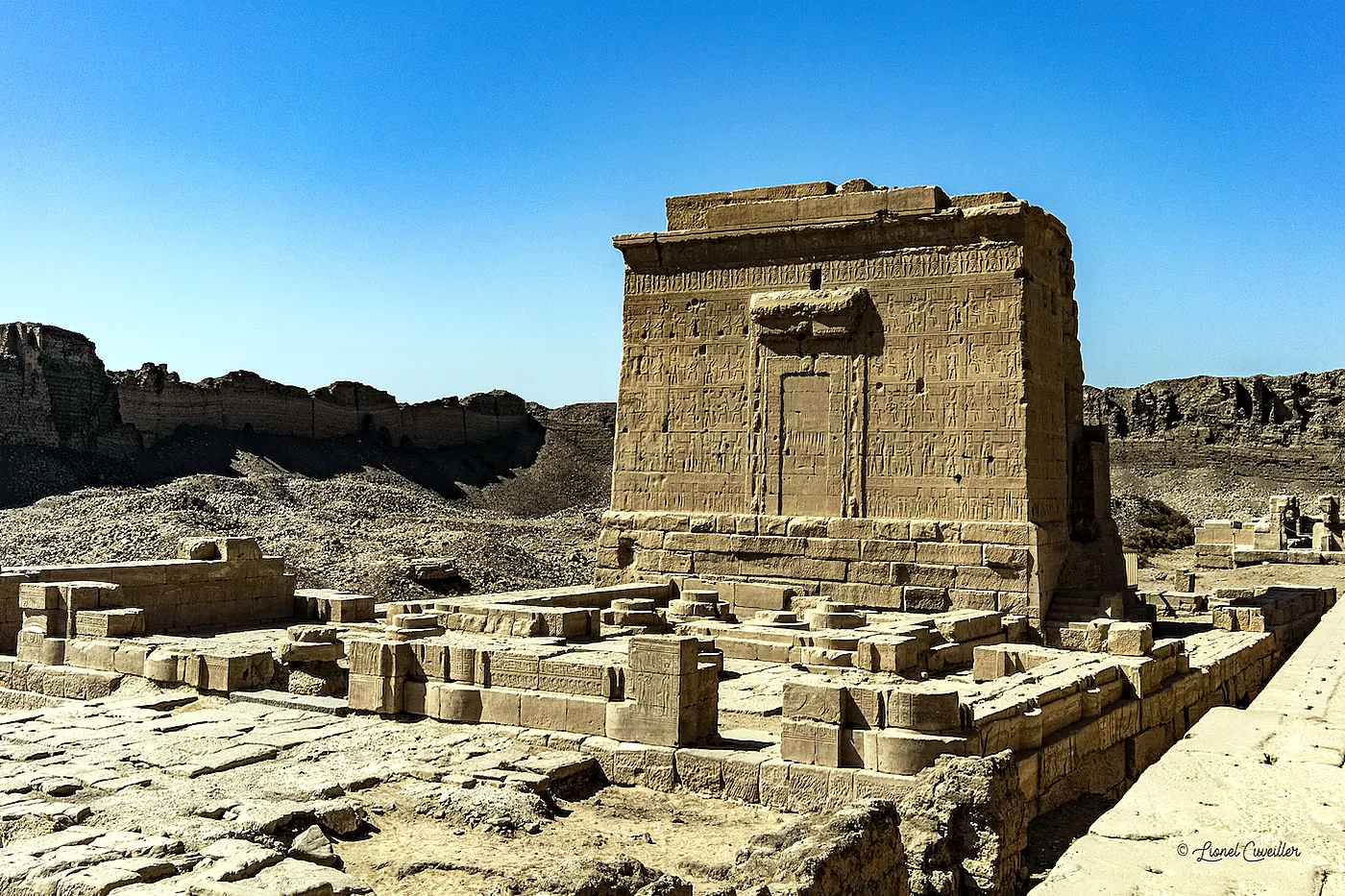 Exterior facade and Hathor-headed columns of Dendera Temple, seen on a Dendera and Abydos day trip from Luxor